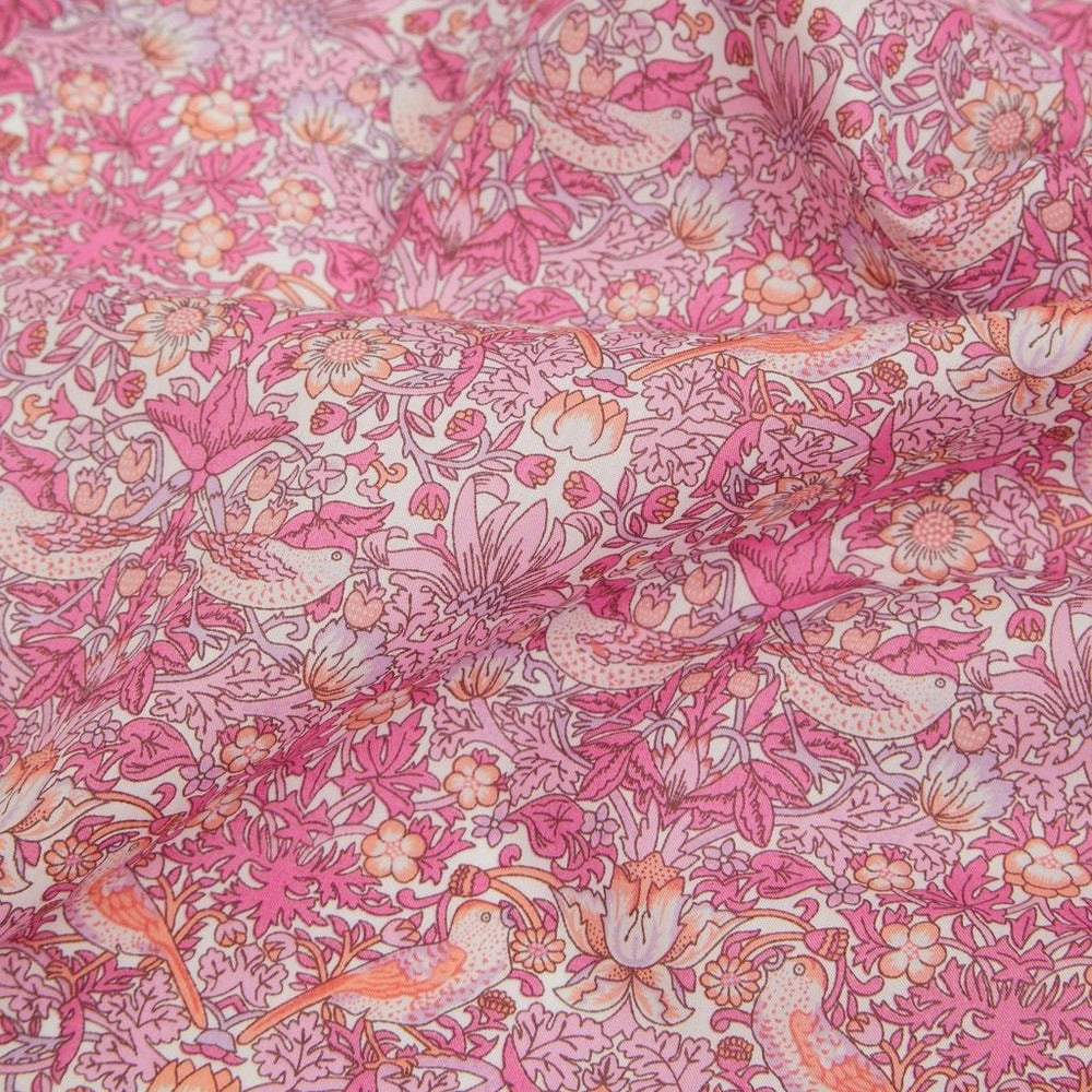 Close-up of pink floral and bird patterned fabric