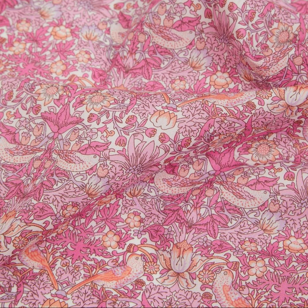 Close-up of pink floral and bird patterned fabric